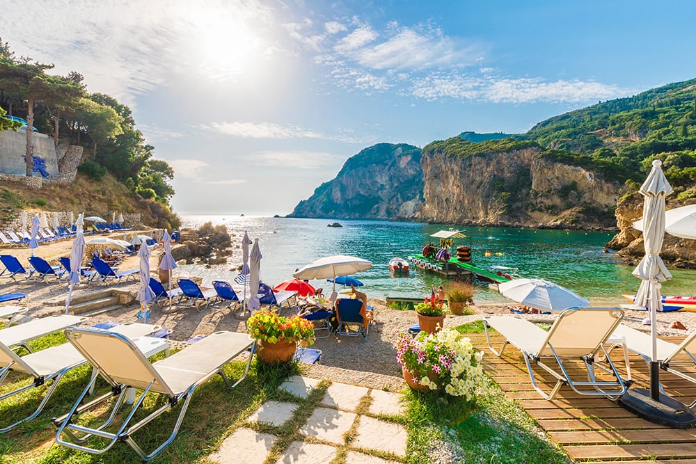 Sunbeds and umbrellas near beach on Corfu Island, Greece